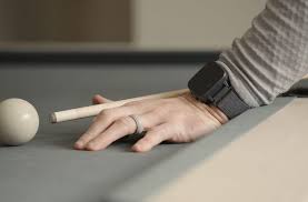 Felix™ NeuroAI™ watch on left arm of pool player