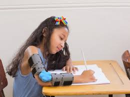 Girl writing at desk with Move-D Orthotic Brace