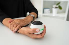 Woman sitting at table holding Vilim ball™